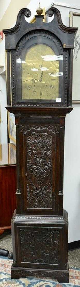 English oak tall clock with carved door and base,